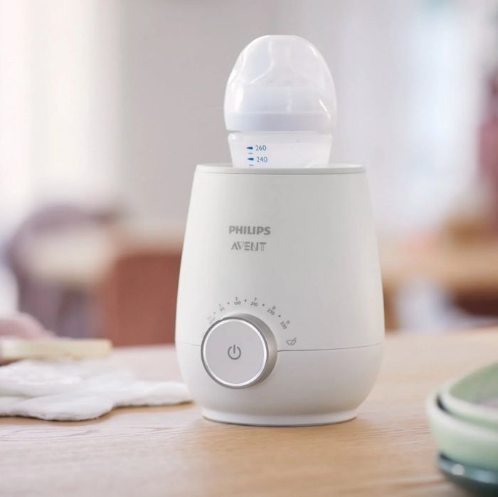 Philips Avent bottle warmer placed on a kitchen counter, with a baby bottle inside, showcasing its convenience for infant feeding.