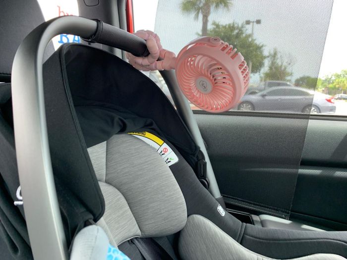 A reviewer’s photo of the stroller fan attached to a car seat