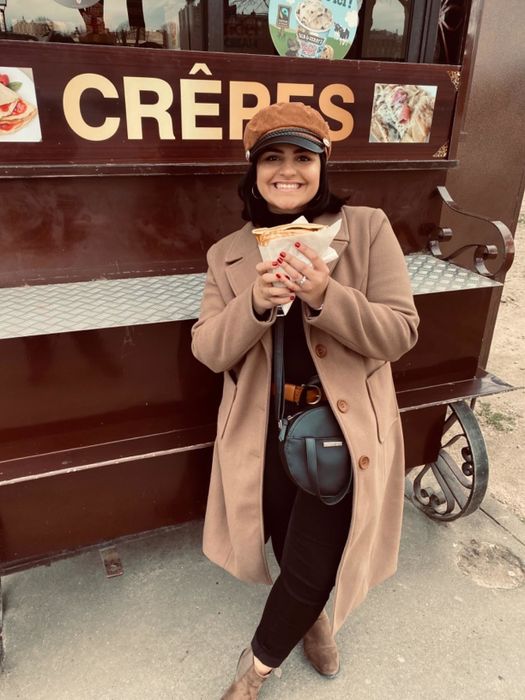 A reviewer wearing the long coat in tan