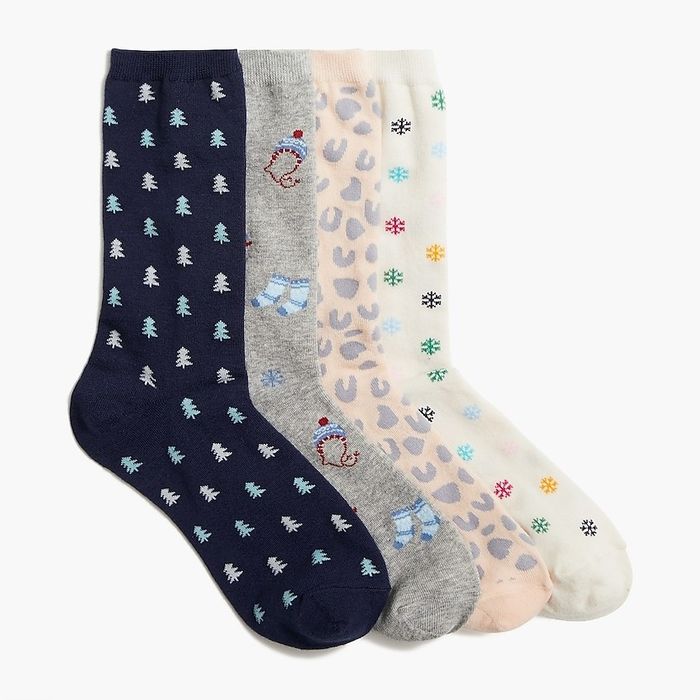 A collection of four pairs of socks in shades of navy, grey, pink, and white