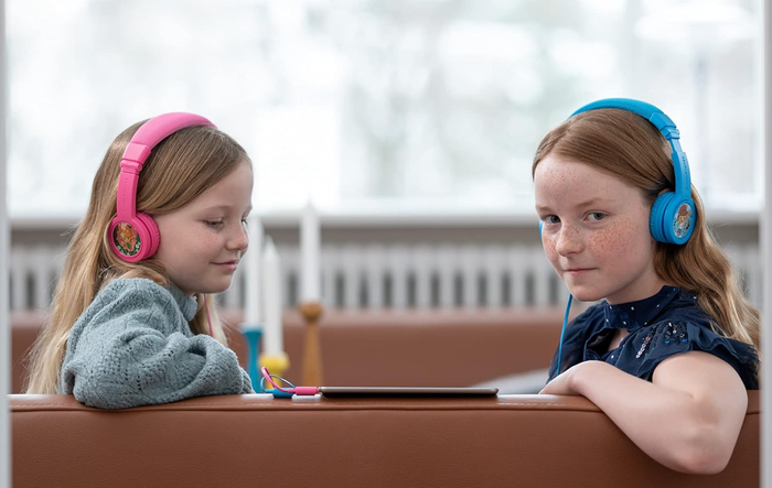 Two kids modeling the headphones
