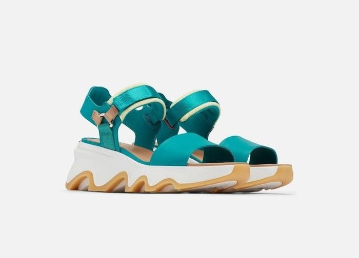 The white padded sandal featuring teal straps