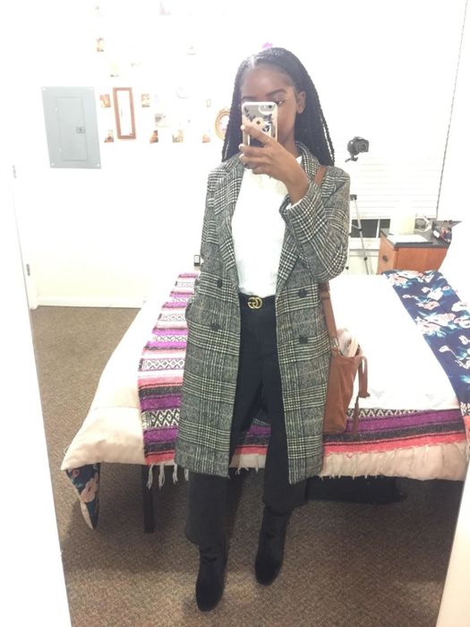 A reviewer sporting the long gray plaid coat