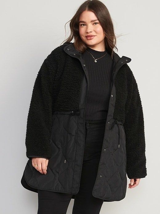 Model dressed in a black quilted fleece jacket.