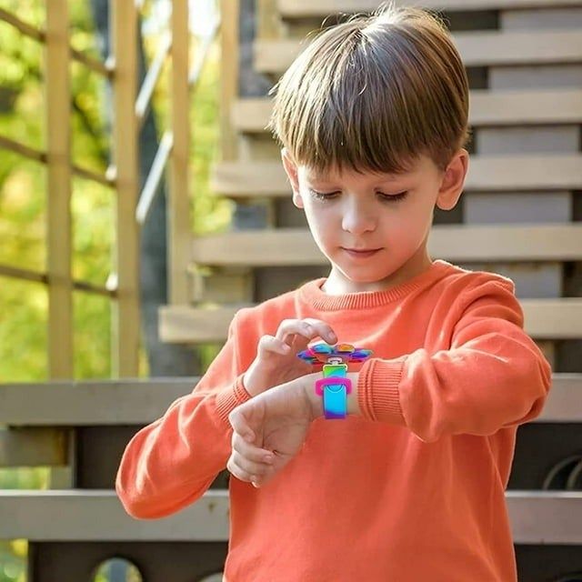 A child wearing a rainbow-colored poppable bracelet