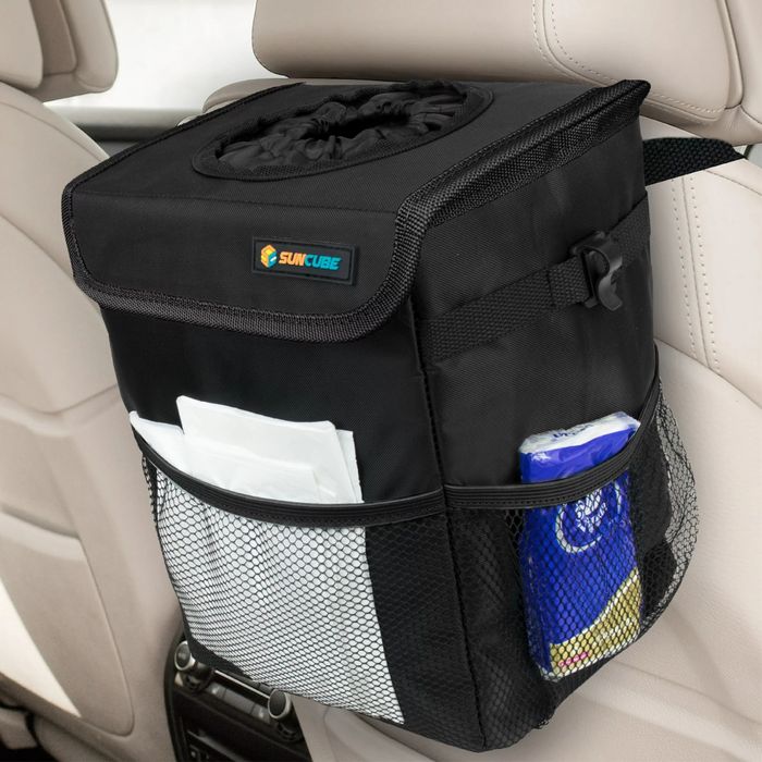 A black soft waste bin attached to the back of the passenger seat