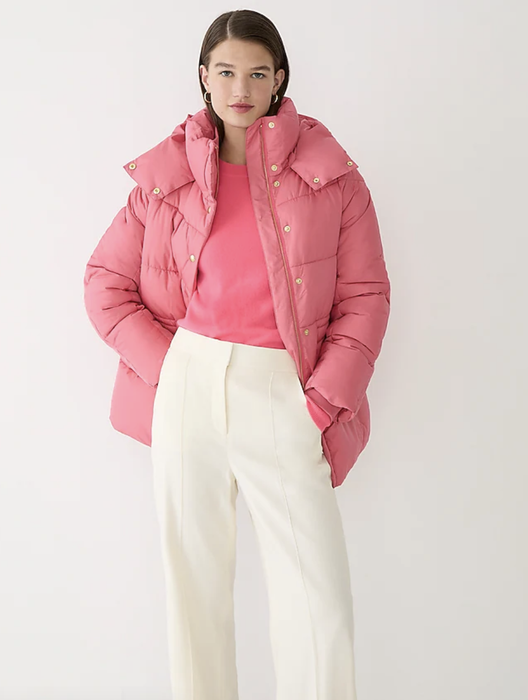 Model wearing a pink puffer coat.