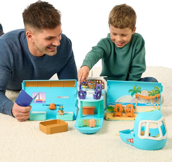 A parent and child playing with the Bluey set