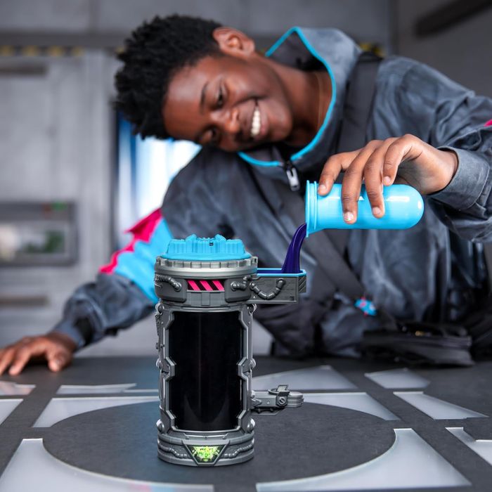 A child pouring liquid into the packaging of a Mr. Beast toy