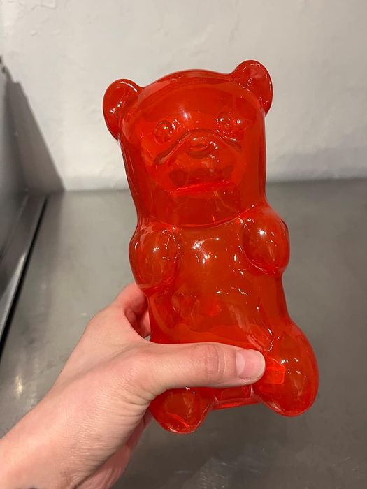 Reviewer holding their red gummy bear lamp.