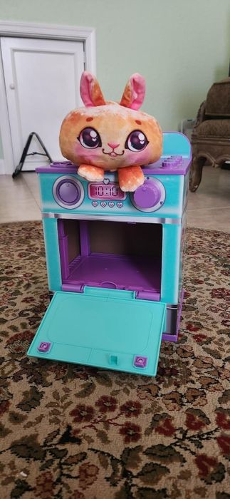Plush toy sitting on top of the Cookeez Makery oven