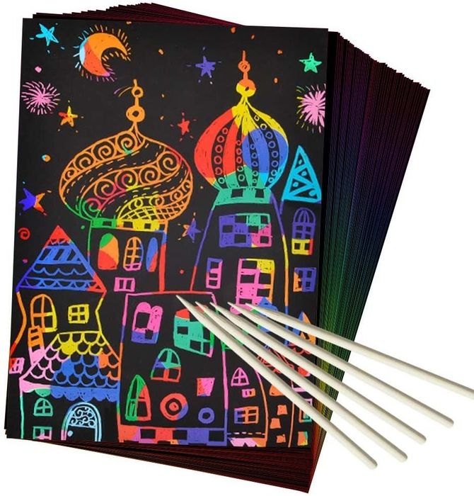 The scratch art featuring a rainbow-colored castle along with wooden drawing tools.