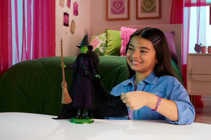 A child playing with the Elphaba doll