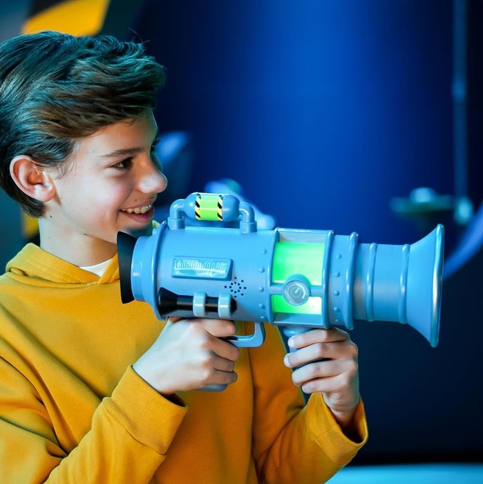 A child holding a Minions fart blaster