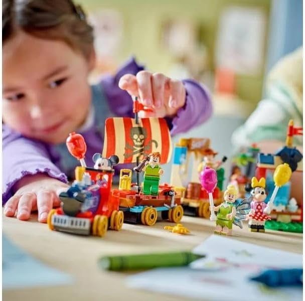 A child playing with the Disney-themed Lego train set