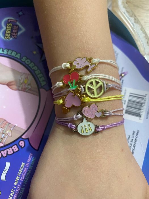 A stack of bracelets adorning a child's arm.