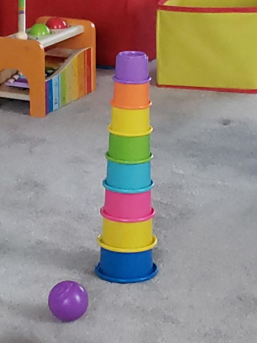 A stack of colorful rainbow toy cups