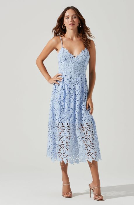 A model is wearing the light blue version of the dress.