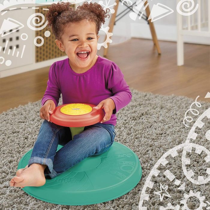 Child sitting on the Sit 'n Spin toy