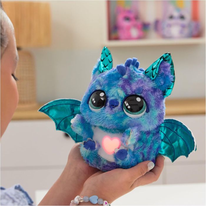 Child holding a Hatchimals stuffed animal