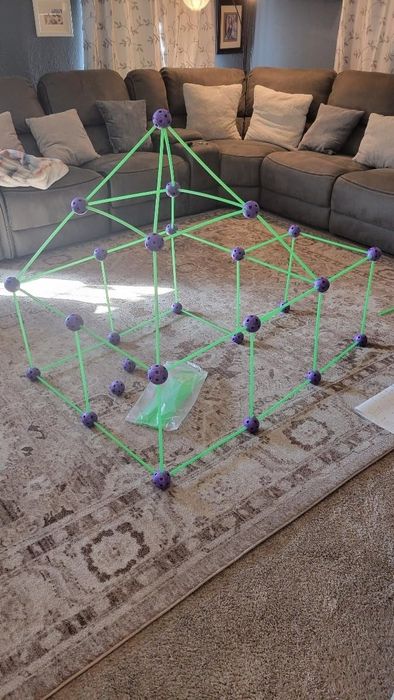 Reviewer's living room featuring a fort they've built in the center of the room