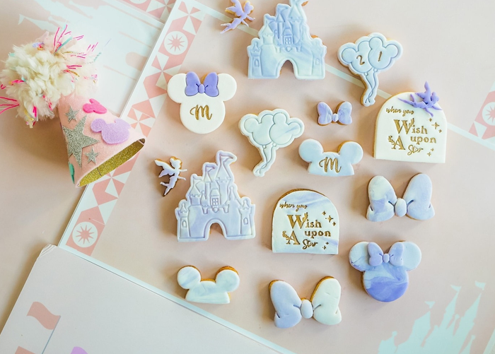 Disney-themed cookie cutters with fondant decorations embossed on them