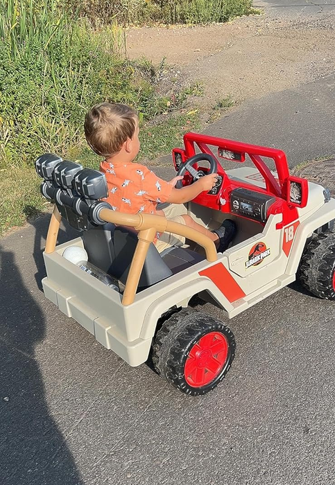 Image of a reviewer’s child sitting in the Jurassic Park Jeep