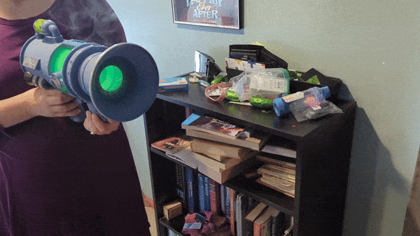 A reviewer using a Minions fart blaster