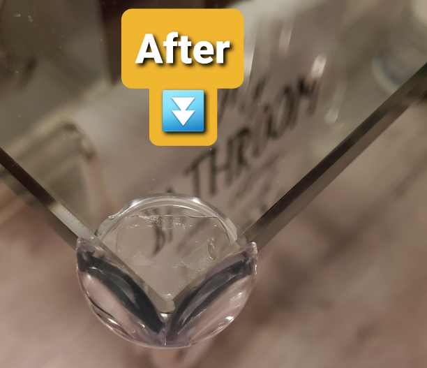 After image of the same glass table, now equipped with clear corner guards for added safety.