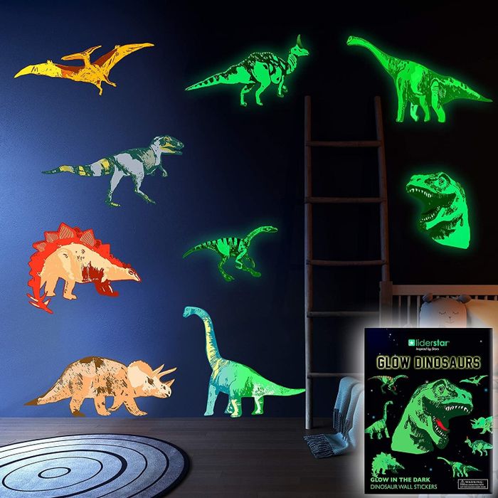 Dinosaur decals glowing brightly on a blue wall.