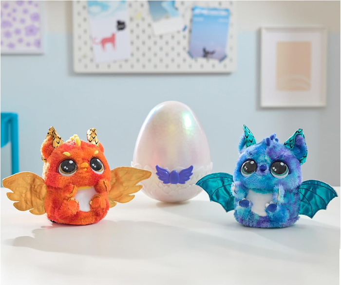 Two Hatchimals stuffed animals next to the plastic egg packaging