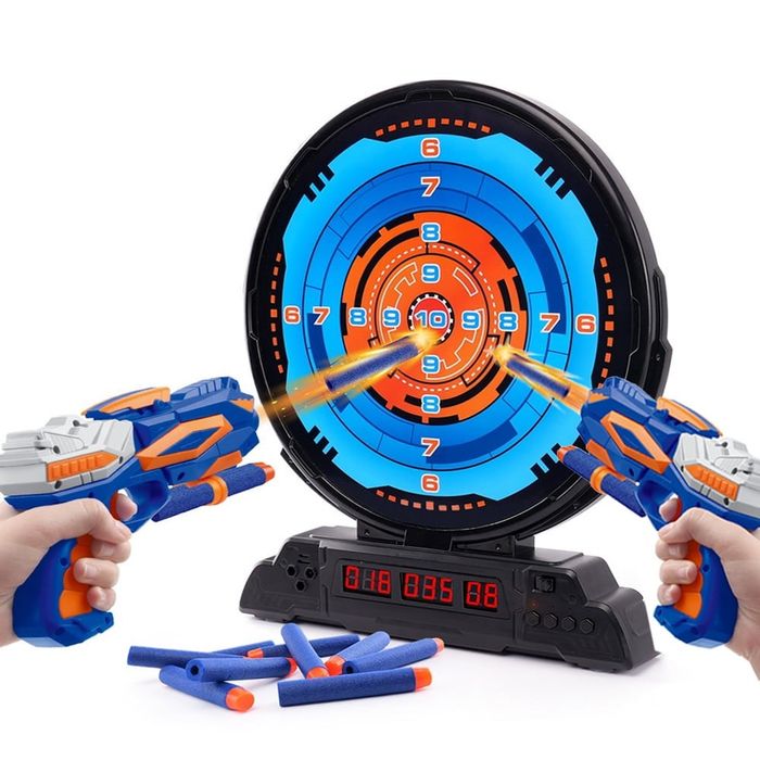The Nerf blasters firing darts at the target.