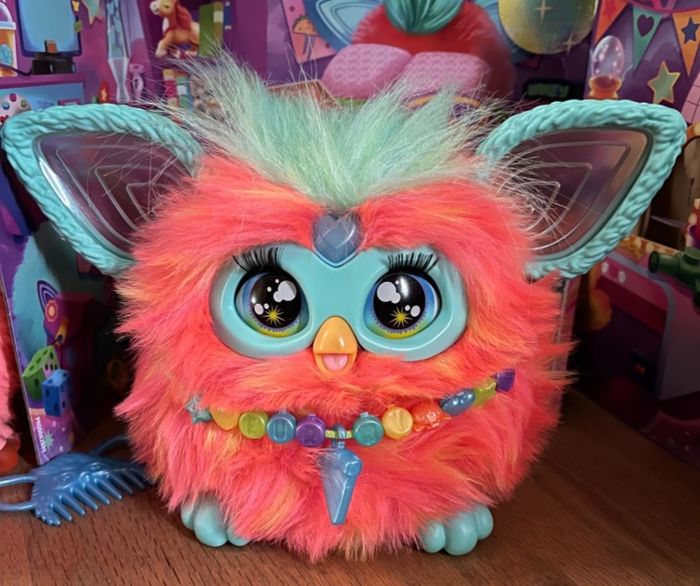 Toy with vibrant fur, oversized ears, wide eyes, and a beaded necklace, set in a lively and playful display