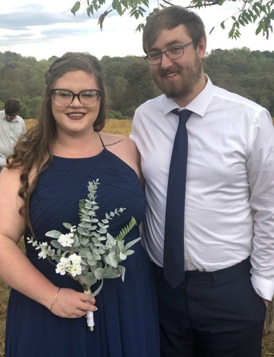 A reviewer wearing the dress in navy