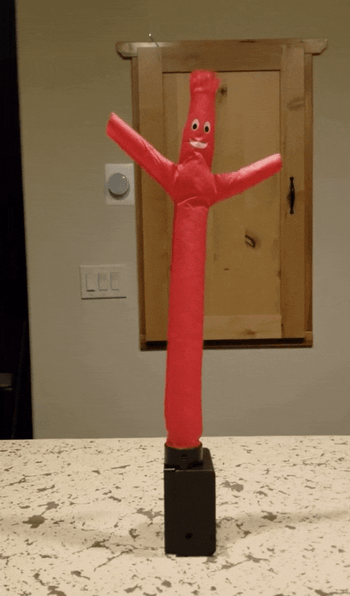 GIF of a reviewer demonstrating the inflatable tube guy in action