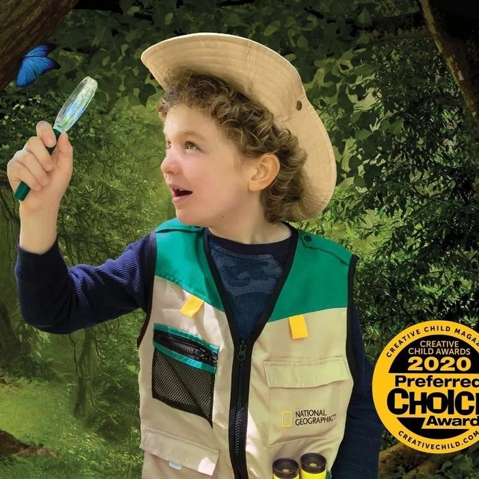 A child dressed in the vest and hat, using the explorer tools