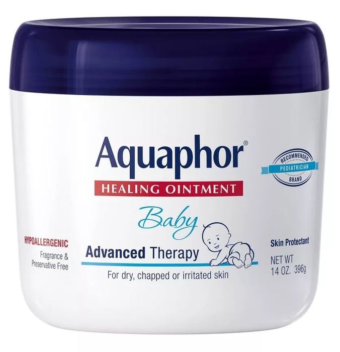 A white jar of healing ointment with a navy blue lid