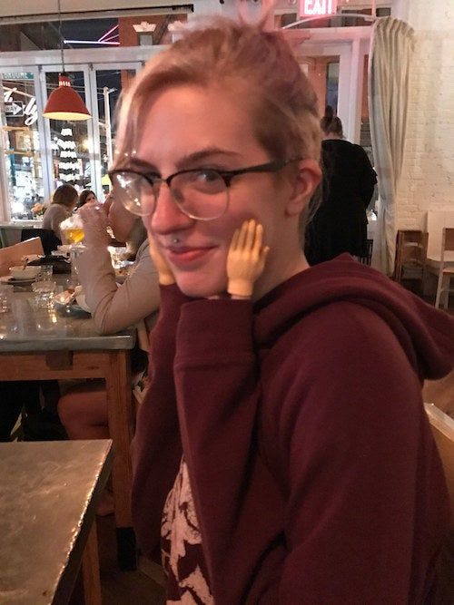 Mytourer posing with small hands placed on her cheeks
