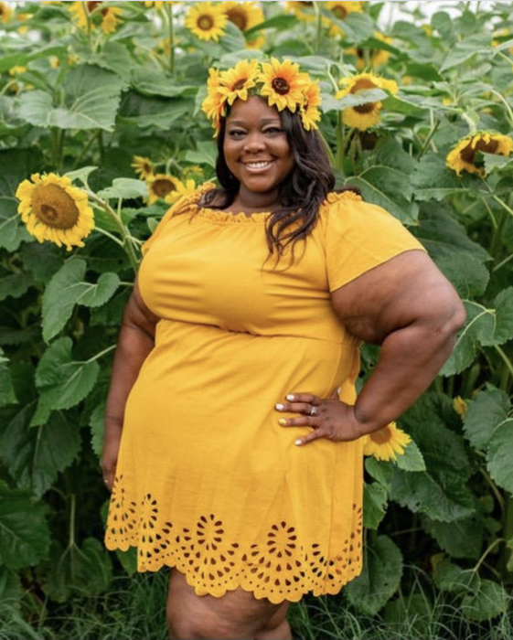 Reviewer wearing the yellow version of the dress, which hits mid-thigh and cinches at the waist