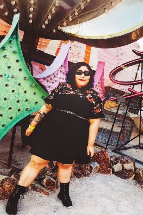 A reviewer sporting the dress in classic black.