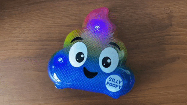 A GIF showing the multicolored plastic Silly Poopy lighting up