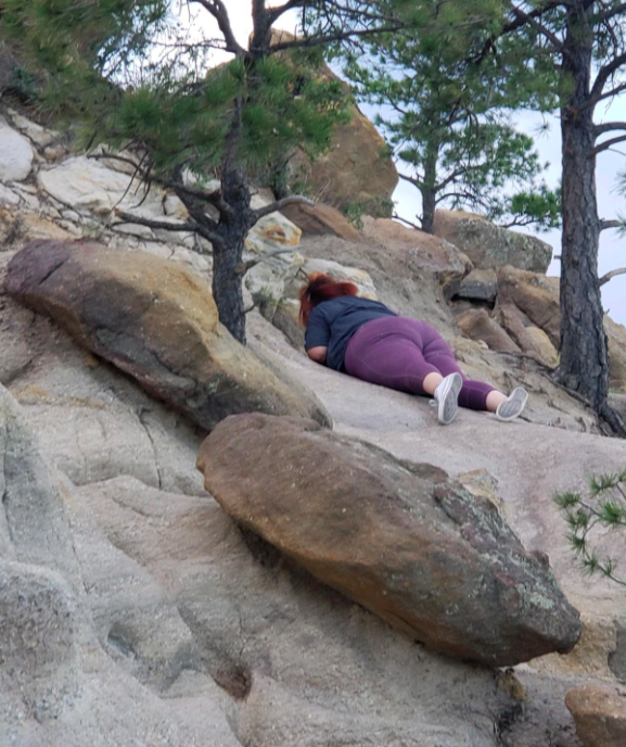 A customer review photo capturing them sliding down a hill while wearing the leggings.
