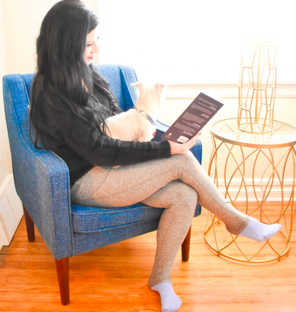 A photo from a customer review showing them reading while wearing the pants.