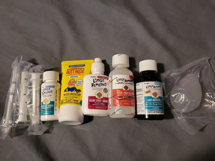 A collection of essential baby care products, including Little Remedies saline spray and drops, Butt Paste, fever and pain reliever, gas relief drops, and a nasal aspirator.