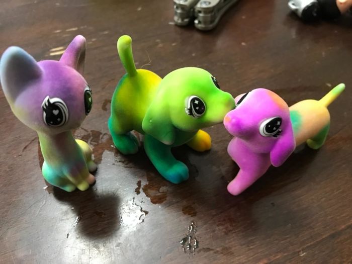 A reviewer's photo showing three colored animal figures