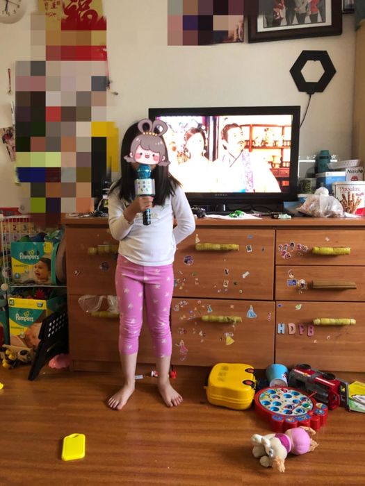 Reviewer's child holding the blue microphone