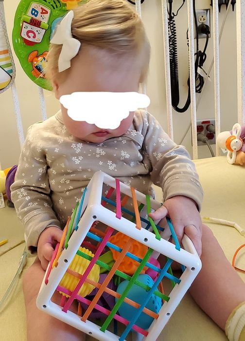 Reviewer's child enjoying playtime with the bin and shapes