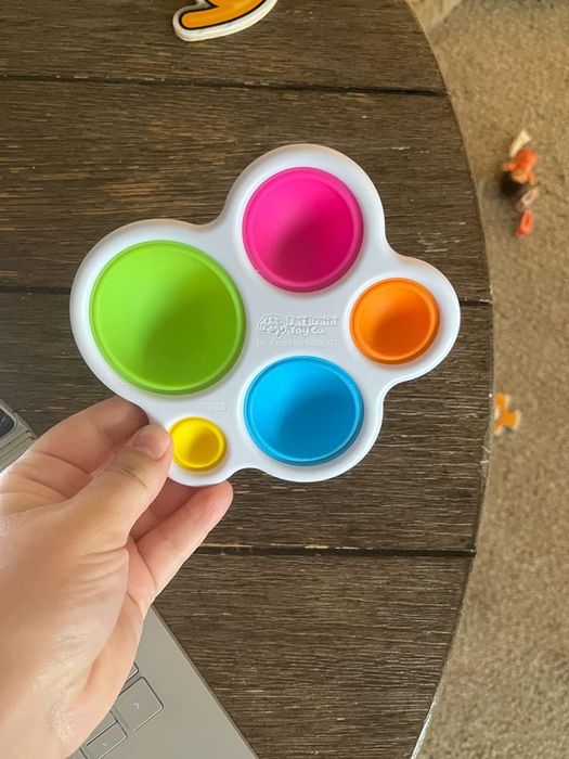 A reviewer holding the toy in their hand