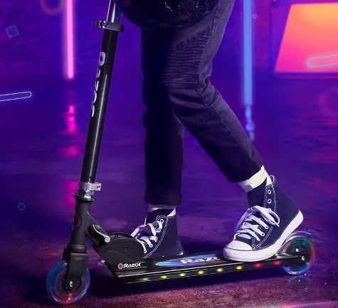 Close-up of feet on a scooter