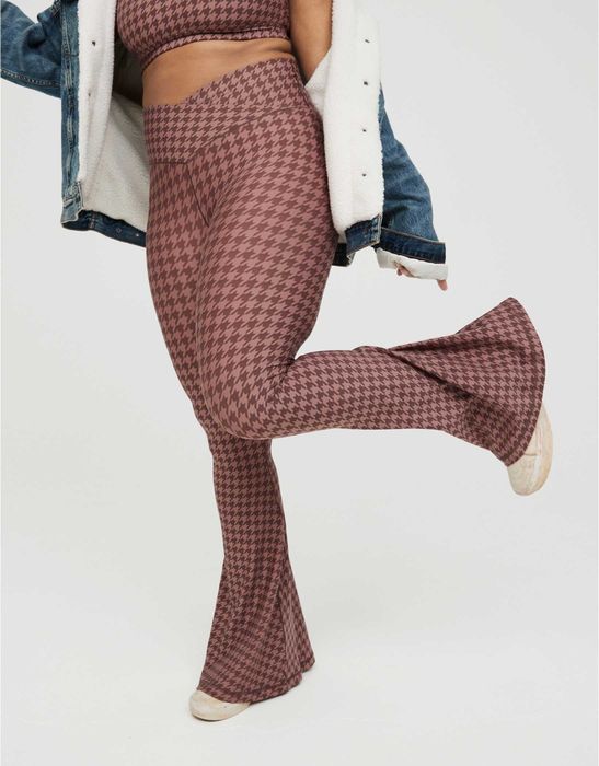 A model showcasing burgundy checkered fit-and-flare leggings styled with a denim jacket